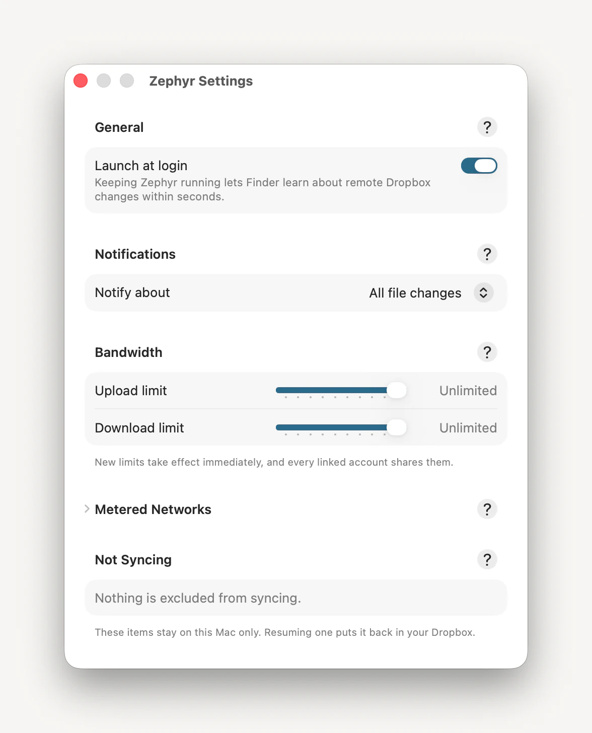 Zephyr’s Settings window: Launch at login switched on, Notify about set to All file changes, unlimited upload and download limits, a collapsed Metered Networks section, and an empty Not Syncing list.